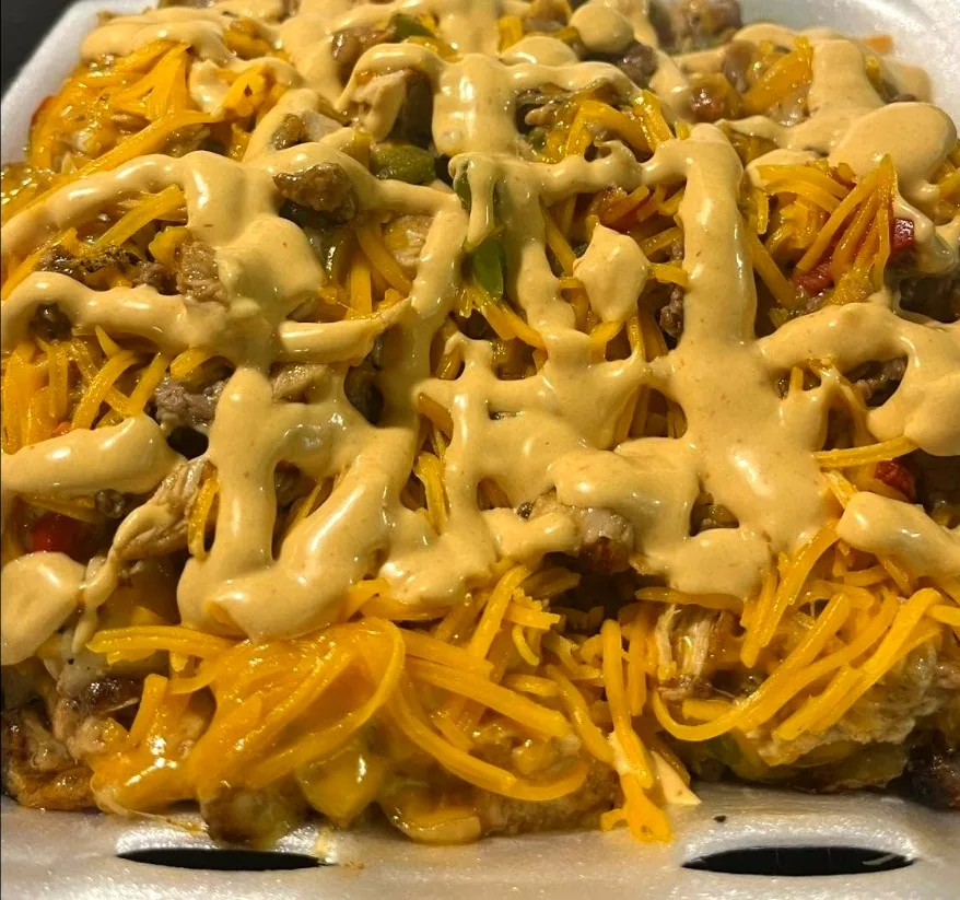 The Trainwreck — a loaded plate of meat, peppers and potatoes buried under shredded cheddar and cheese sauce